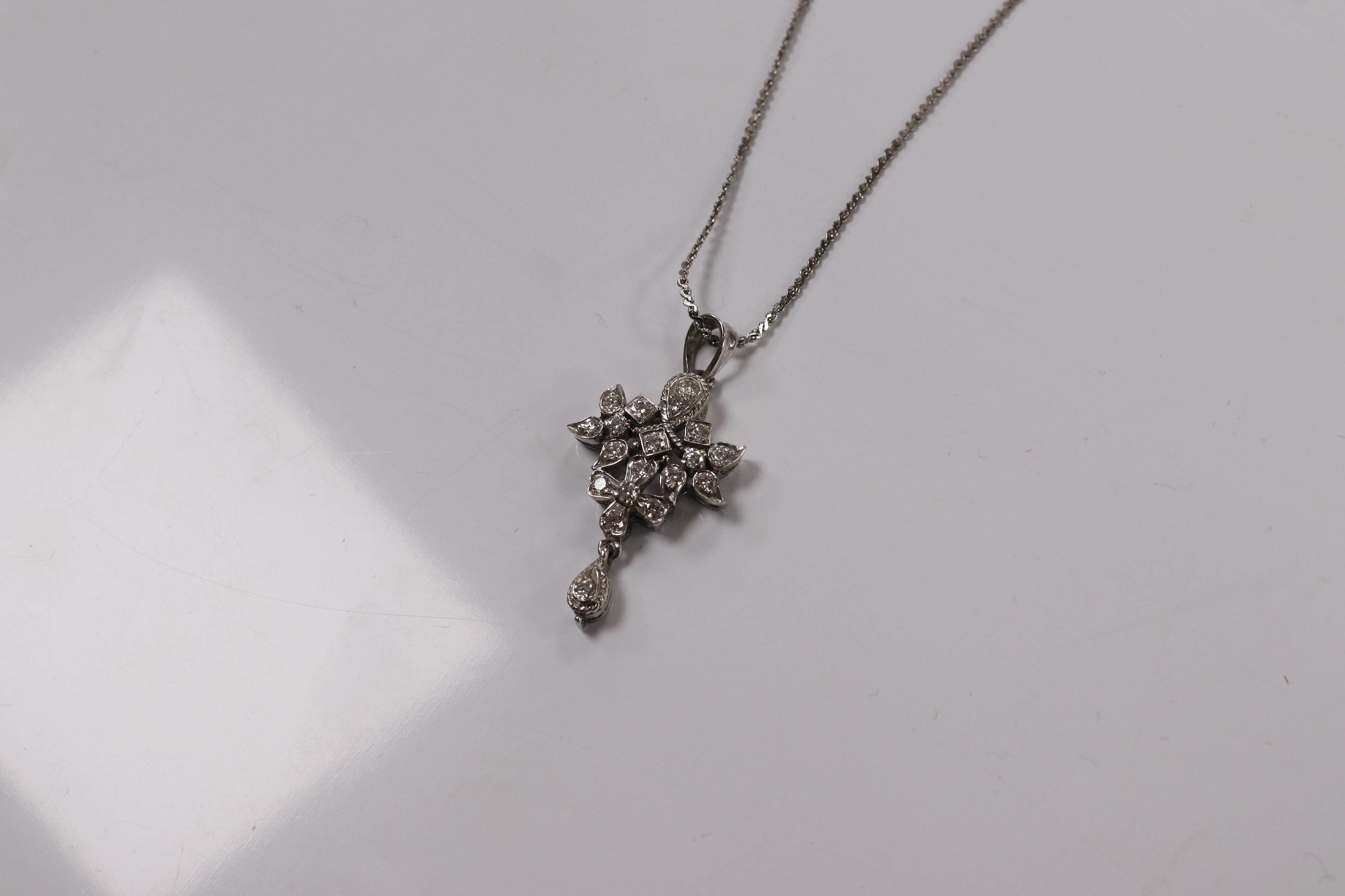 A modern white metal and diamond chip cluster set drop pendant, 33mm, on a base metal chain. Condition - fair